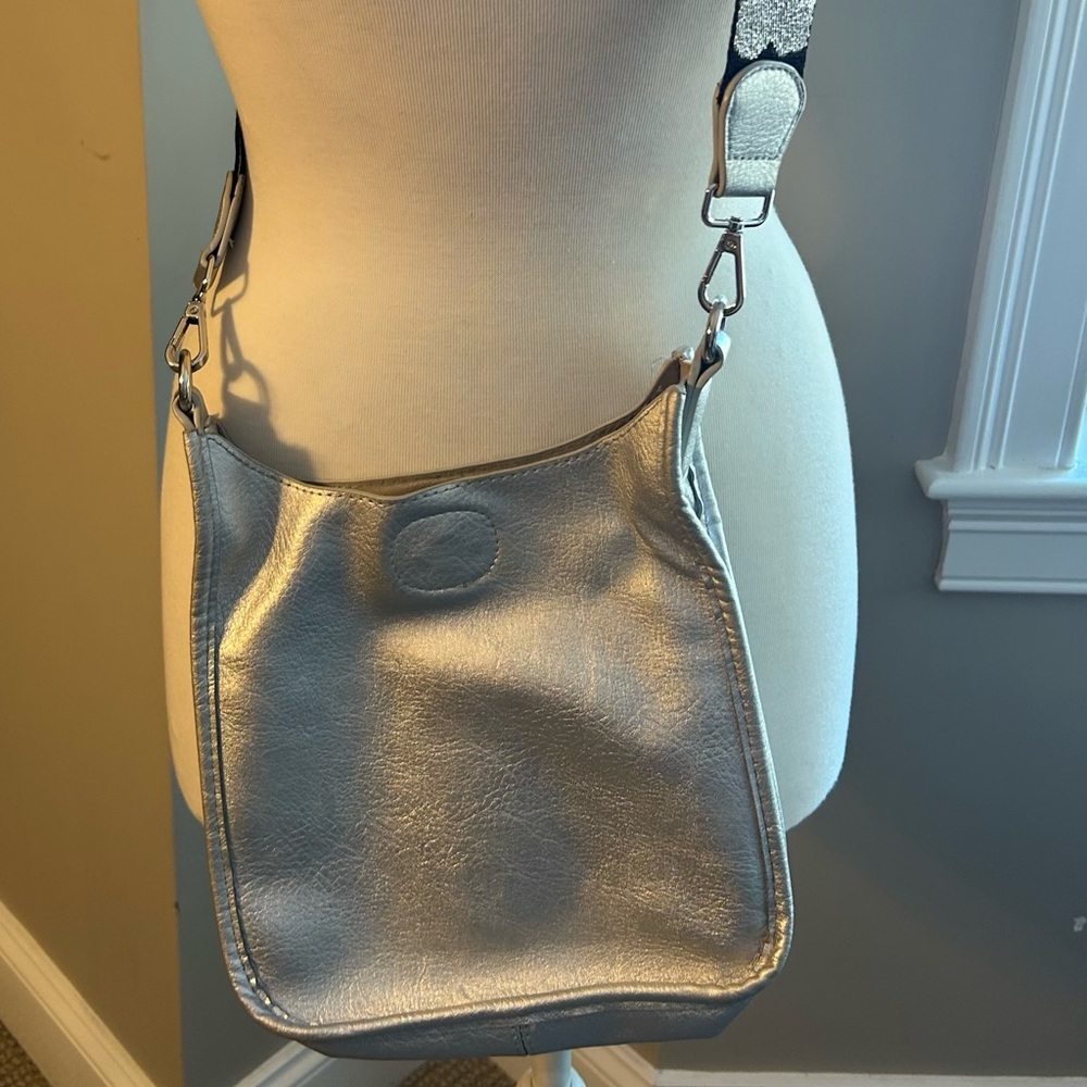 Ah-dorned vegan leather silver crossbody bag.